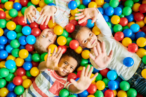 Above,View,Portrait,Of,Three,Happy,Little,Kids,In,Ball